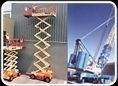 Scissor lifts and a crawler crane parked in the yard.