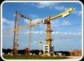 Two tower cranes standing over a low-rise site.