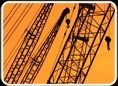 Crane masts silhouetted against an evening sky.