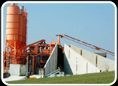 Concrete batching plant with storage silos.